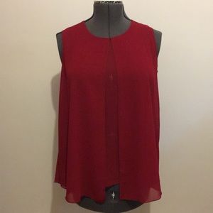This dark red sleeveless blouse is NWT.